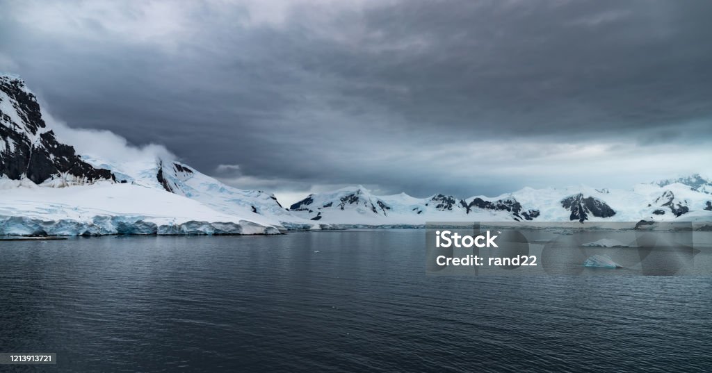 Antarctic landscape Mountains and glaciers in the Antarctic peninsula. Iceberg - Ice Formation Stock Photo