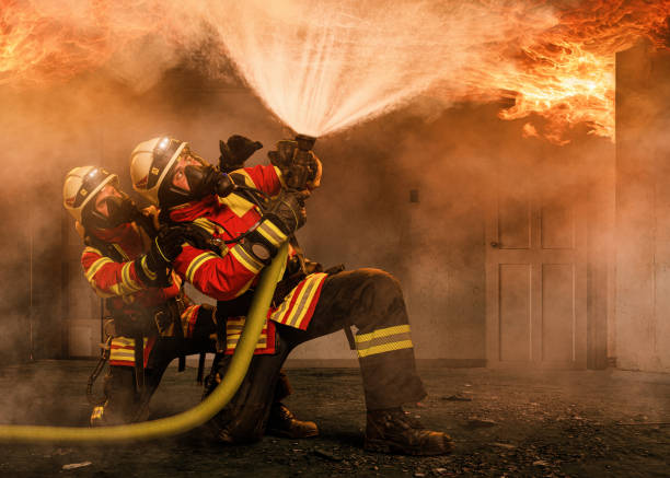 istock Two firefighters in a burning house 1213913922