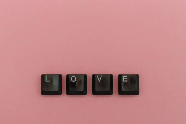 istock Love concept with keyboard letters on pink background . Horizontal view. 1213915384