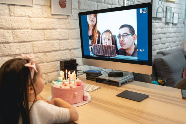 istock Little girl sharing birthday on a same day with her sibling and they celebrating it over video call app 1213915549