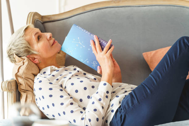 istock Female holding an astrology book with both hands 1213917728