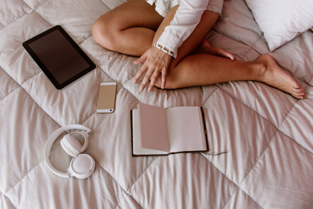 istock woman working freelance from her bed 1213917749