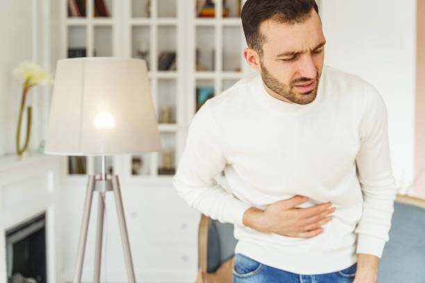 istock Caucasian male suffering from severe stomach spasms 1213917752