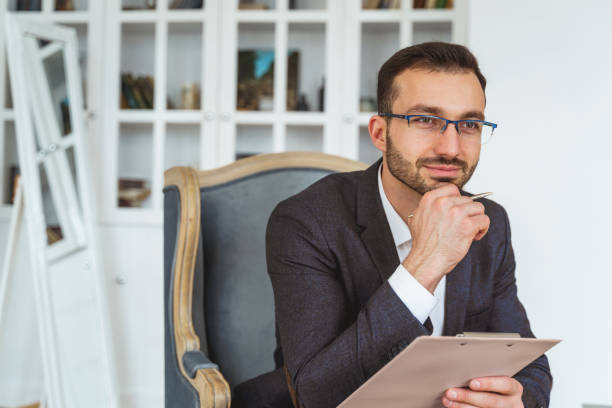 istock Dreamy young dark-haired man holding a clipboard 1213917836