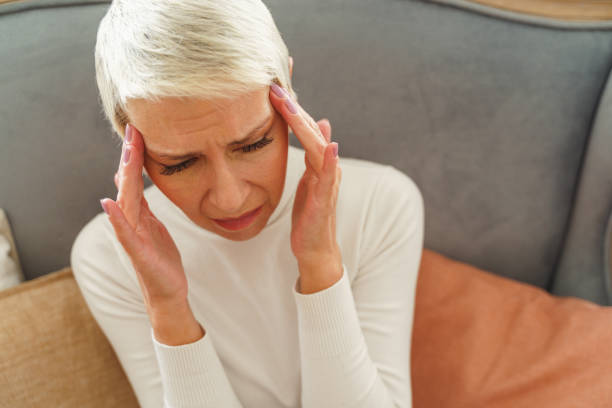 istock Depressed woman with her hands on the temples 1213917950