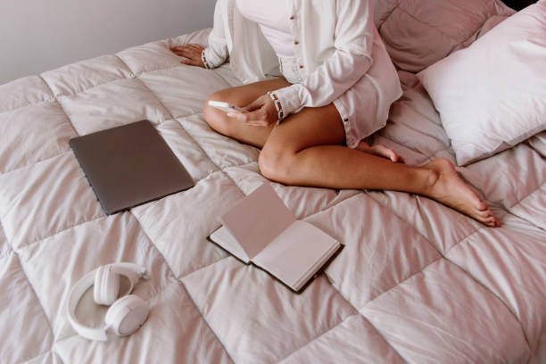 istock businesswoman with mobile on bed 1213918008