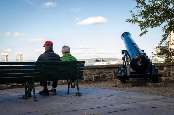 City of Quebec. Quebec, Canadá September 27,2019: An elderly couple sitting and contemplating the quebec's landscape in Rue des Remparts viewing point. north quebec stock pictures, royalty-free photos & images