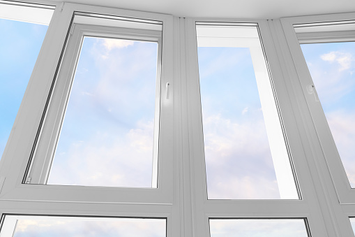 Large white plastic window against blue sky. Low angle view