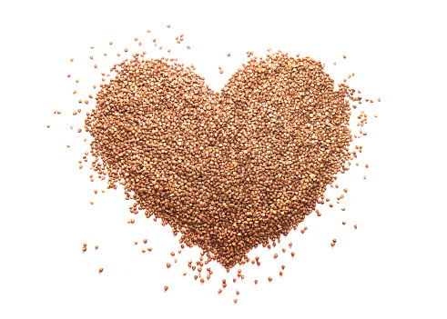 Food background of buckwheat grain bunch in shape of heart
