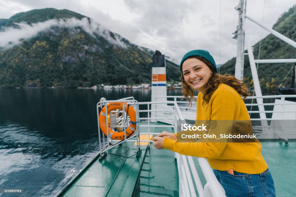 Woman traveling by ferry in Norway Young Caucasian woman traveling by ferry in Norway Norway Stock Photo