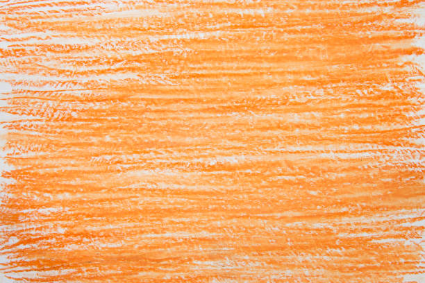 istock orange vax crayon on white paper background texture 1213921344