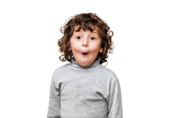 Portrait of excited little girl staring at camera over white background