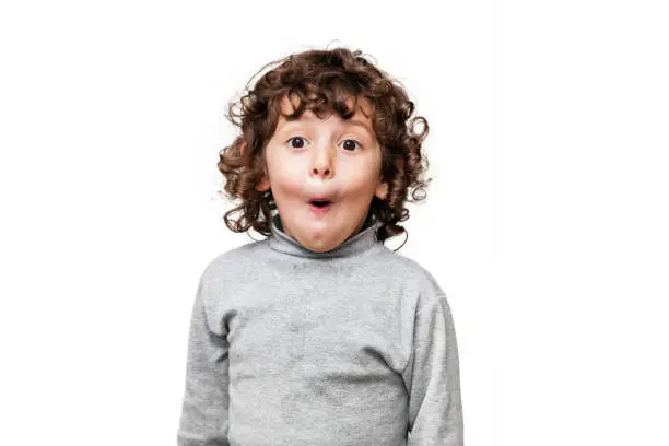 Photo of Surprised child with mouth open looking at camera
