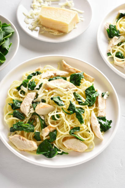 istock Spaghetti with spinach leaves, slices grilled chicken breast and grated cheese 1213921839