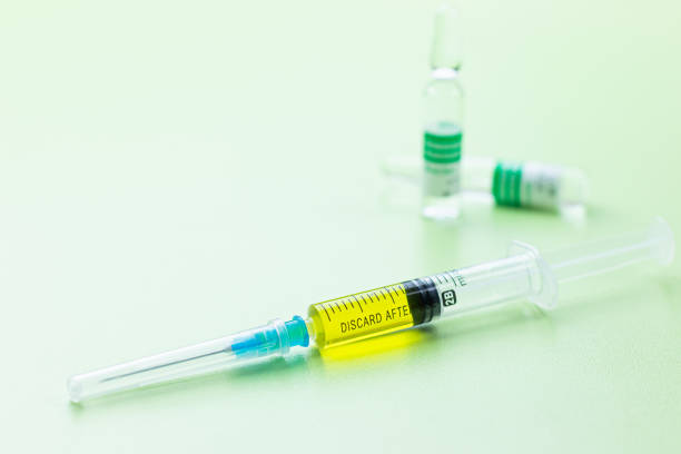 istock Small bottle and syringe on medicine table ready for injection vaccine for coronavirus 1213922526