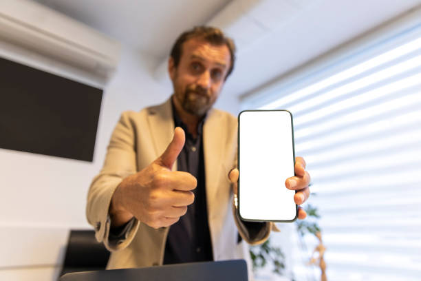istock This is for you. Business man showing something on smartphone screen 1213922789