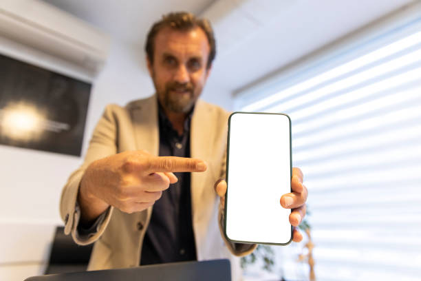 istock I recommended this content. Business man showing something on smartphone screen 1213922807