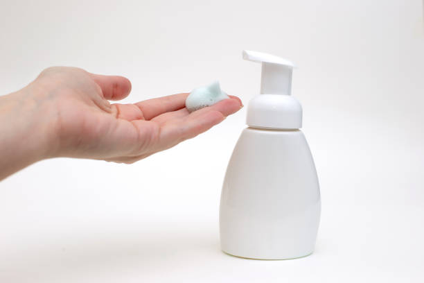 istock Hand on a white background with white foam from a bottle of antibacterial soap 1213923771