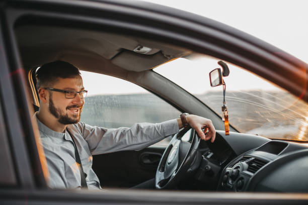 istock Young man driving a car 1213923803