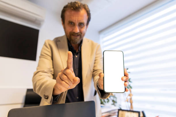 istock This is for you. Business man showing something on smartphone screen 1213923909