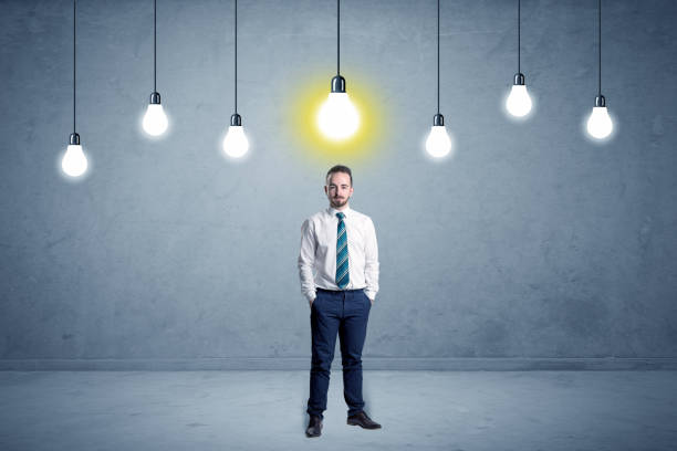 istock Businessman standing uninspired with bulbs above 1213925226