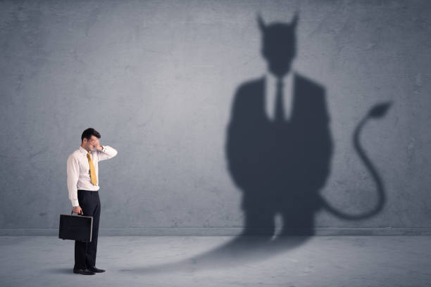 istock Business man looking at his own devil demon shadow concept 1213925308