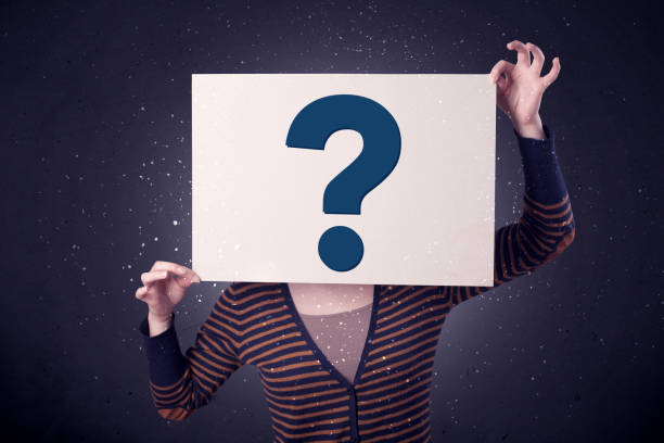 istock Woman holding paper with question marks 1213928466