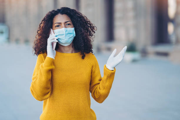 istock Young woman with mobile phone during flu epidemic 1213930679