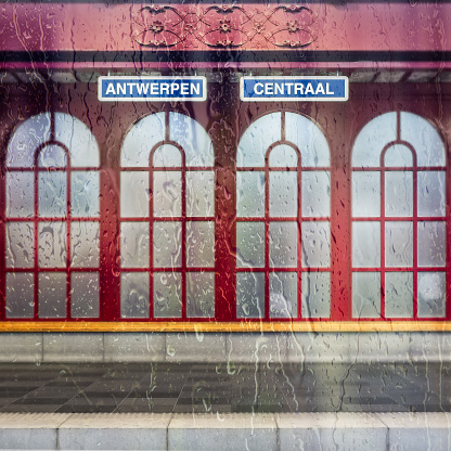 Antwerp Central station name sign though rain covered train window