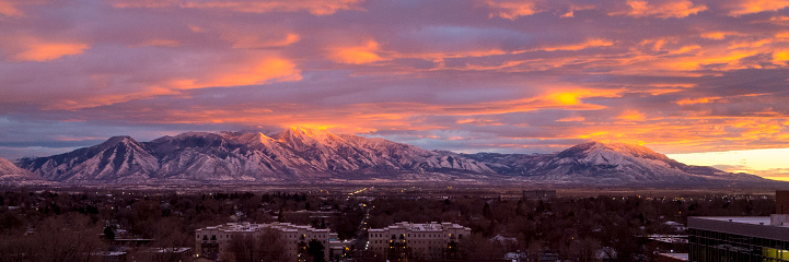 This is a dramatic winter sunset reflecting off the snow on top of the Wasatch mountains in northern Utah.  This shot was taken from Provo, looking south and showing the cities of Spanish Fork and Payson.  The mountains in the background include Mount Nebo, Loafer Mountain and Dry Mountain.