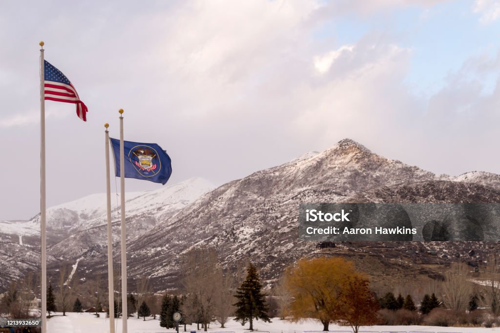 Winter Scene in Midway Utah These are some of the mountains surrounding Midway and Heber City, Utah.  This shot was taken in February when snow still covered most of the ground.  Also visible are the American flag and Utah state flag. Heber City Stock Photo