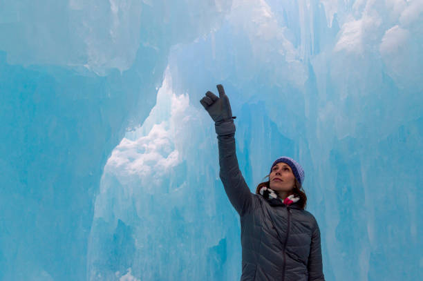 istock Amazed Woman Explorer in an Ice Tunnel 1213932661