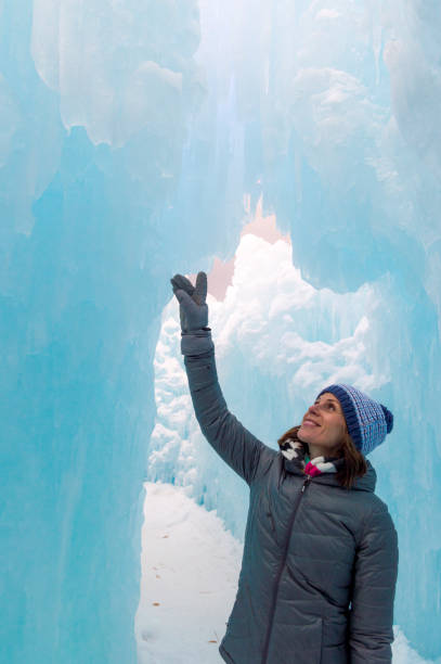 istock Amazed Woman Explorer in an Ice Tunnel 1213932681