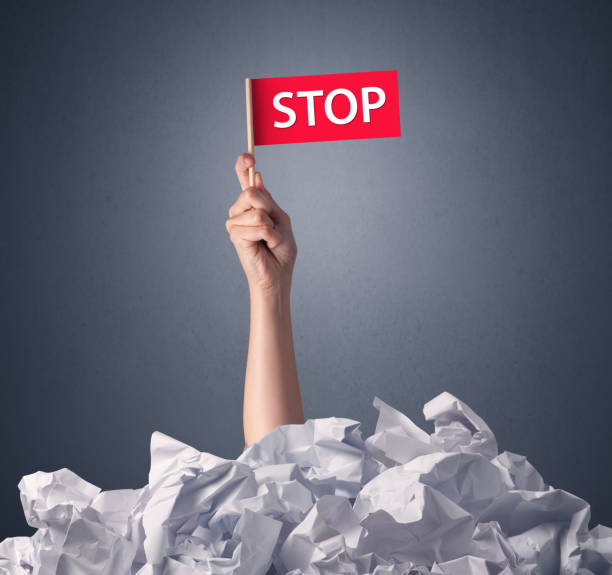 istock Female hand holding stop sign 1213932692