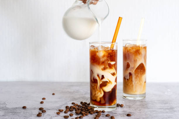 cold brew coffee with milk cold brew coffee with milk in tall glasses iced coffee stock pictures, royalty-free photos & images