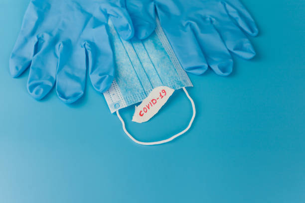 istock protective mask and gloves on a yellow background 1213933278