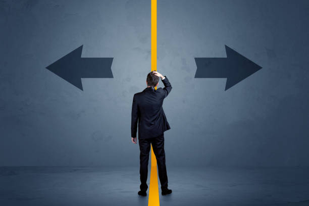 istock Business person choosing between two options separated by a yellow border arrow 1213934030