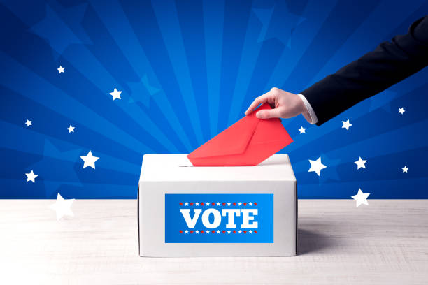 istock hand with ballot and wooden box 1213935251