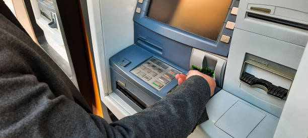 istock Withdrawing money from a cash machine 1213937771
