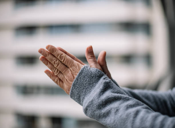 istock Foreground with unfocused background of hands clapping for emergency services during coronavirus quarantine 1213938795