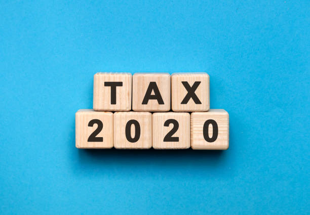istock Tax 2020 - text on wooden cubes, a blue background 1213939492