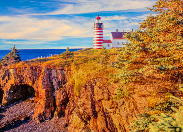 West Quoddy Head Lightouse, Lubec Maine West Quoddy Head, in Quoddy Head State Park, Lubec, Maine, is the easternmost point of the contiguous United States. Since 1808, there has been a lighthouse there to guide ships through the Quoddy Narrows. The current one, with distinctive red-and-white stripes, was built in 1858, and is an active aid to navigation. quoddy head state park stock pictures, royalty-free photos & images