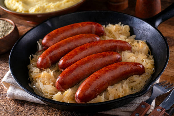 Sausage and Sauerkraut A skillet of delicious smoked sausage and sauerkraut. polish culture stock pictures, royalty-free photos & images