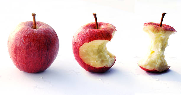 roten apfel beißen - apfelbutzen stock-fotos und bilder