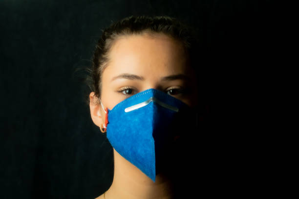 istock Girl protecting herself with mask - Coronavirus - Covid 19 1213944818
