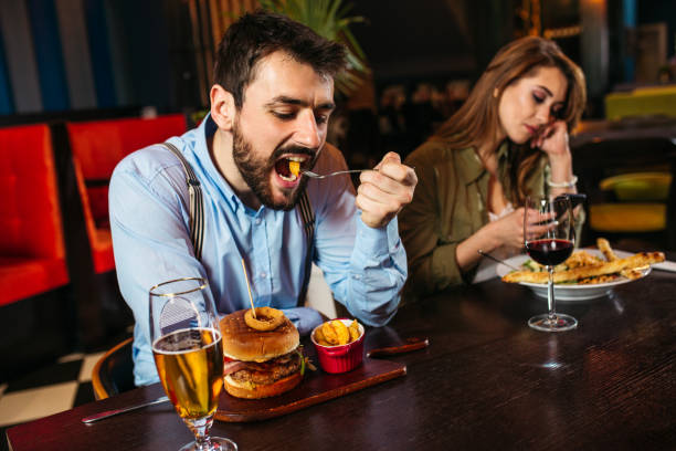 istock Unhappy young couple sitting in restaurant 1213944897