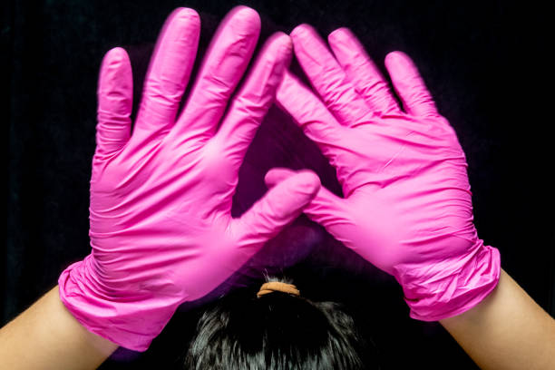 Women's hands dressed in latex glove waving and prepared for a hygiene of the environments. A gesture of bye or even a simple greeting movement.