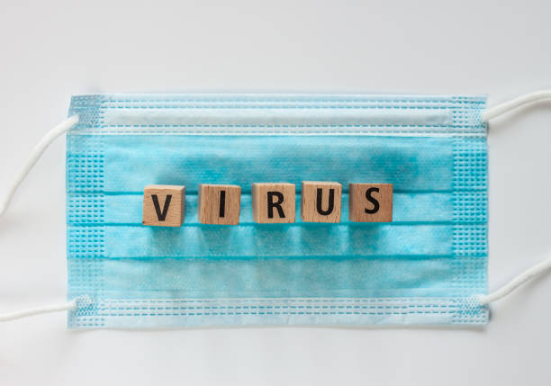 istock virus word on wooden cubes blue surgical mask 1213946172