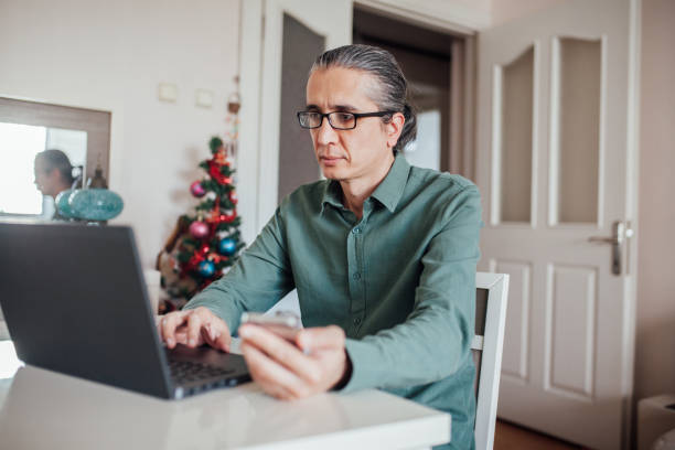 istock Man using smartphone in home office stock photo 1213946239