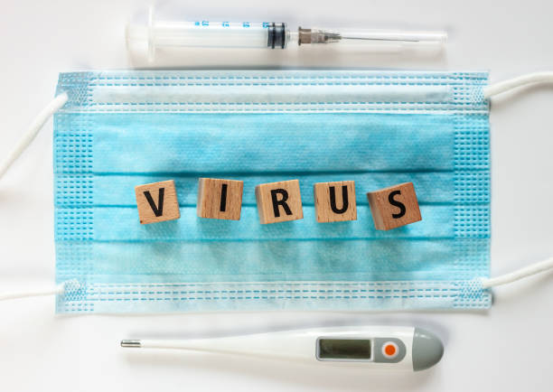 istock virus word on wooden cubes blue surgical mask 1213946796